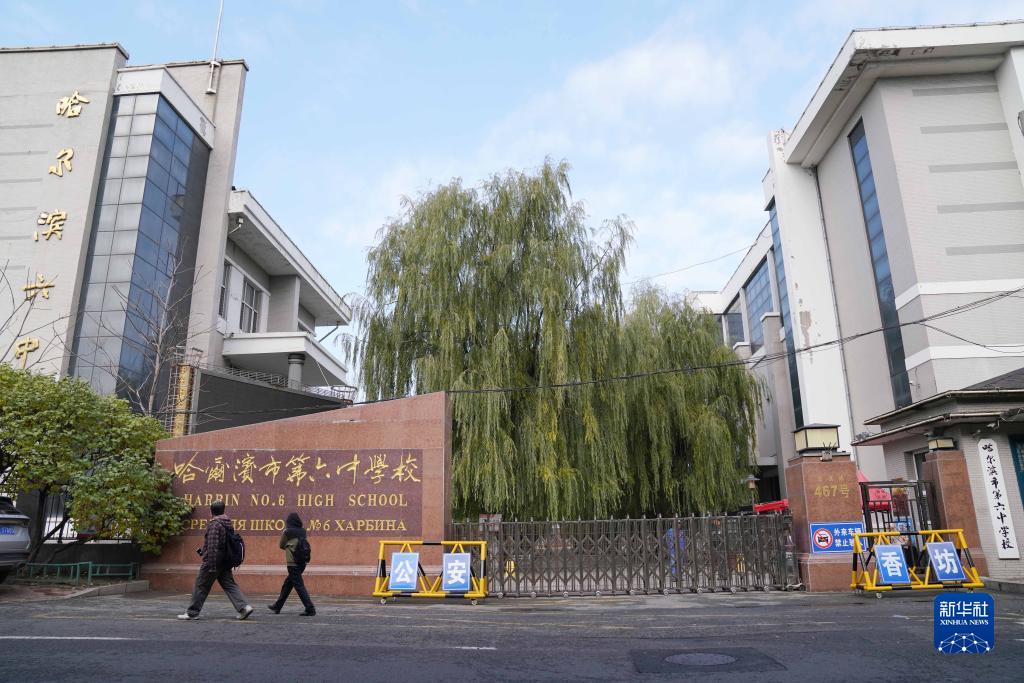 11月1日,市民从大门紧闭的哈尔滨市第六中学校门口经过.